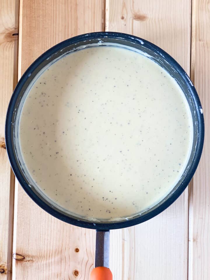 Creamy sauce in round sauce pan.