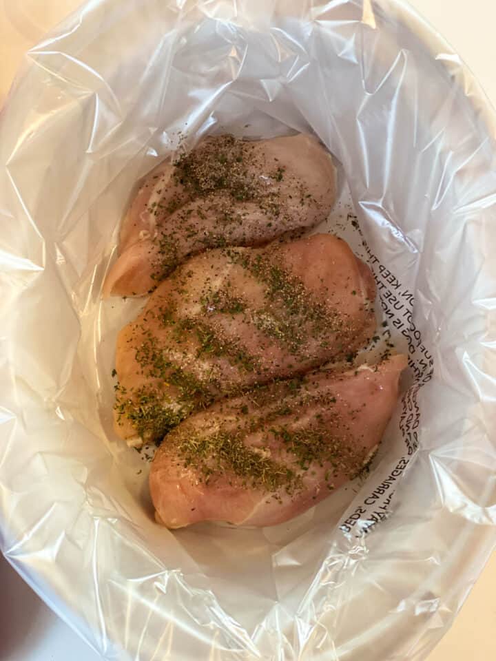 Chicken breast and seasonings add to bottom of crock pot.