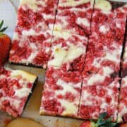 Strawberry cheesecakes brownies sliced and on board.