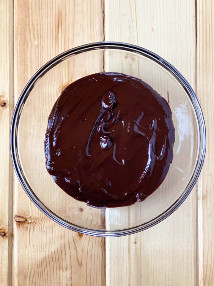 Melted ganache in large glass bowl.