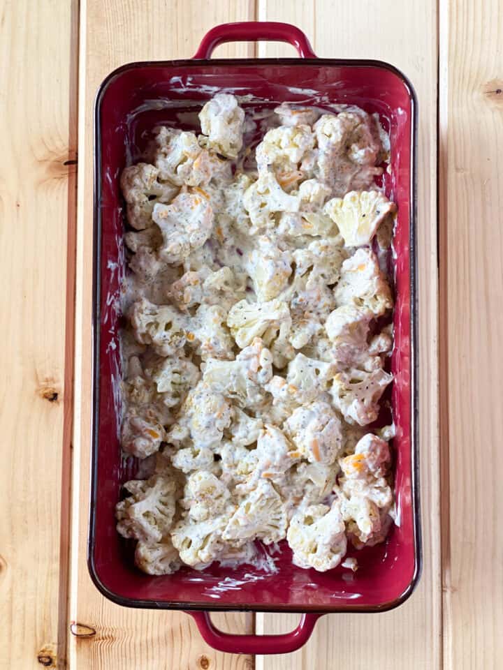 Cauliflower and cheese mixture combined in casserole dish.