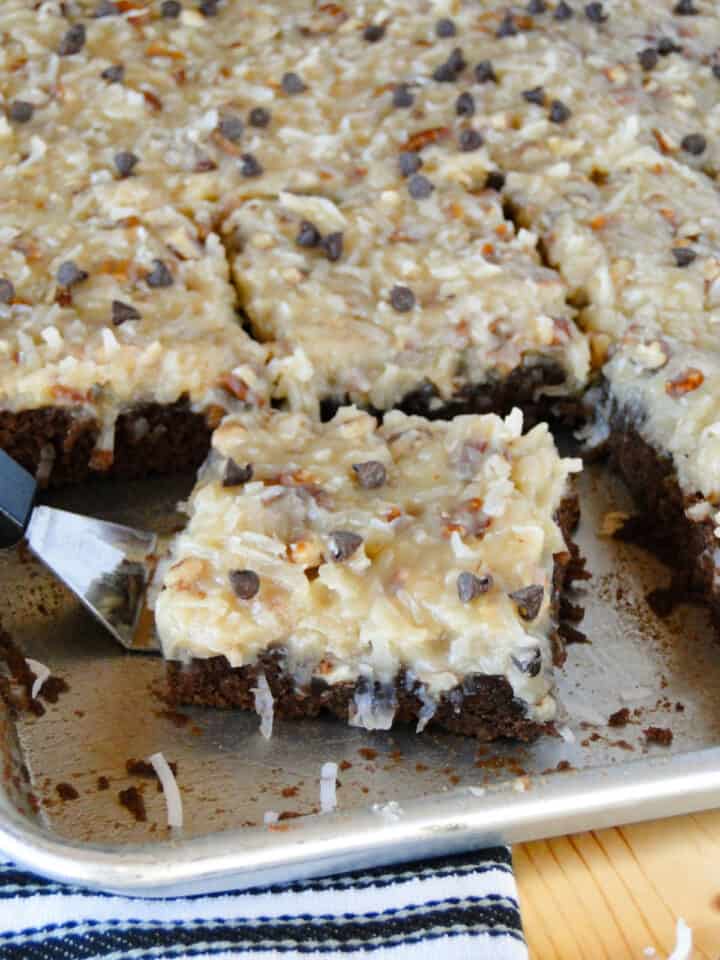 German chocolate cake slice on mini spatula in sheet pan.