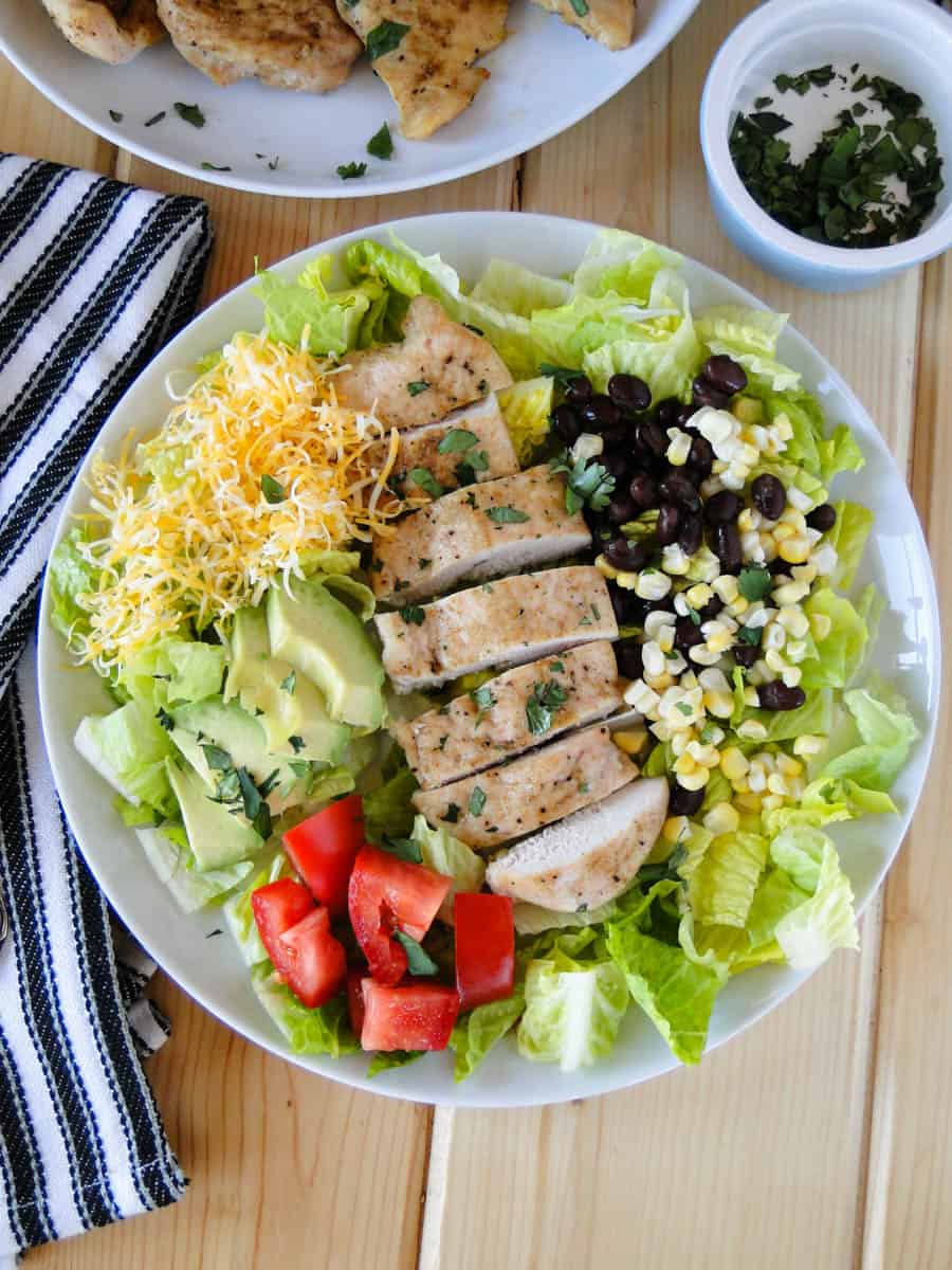 Top view of southwestern chicken salad assembled on white round plate.