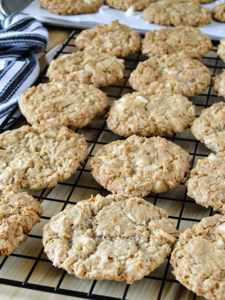 Coconut oatmeal cookies in rows on cooling rack.