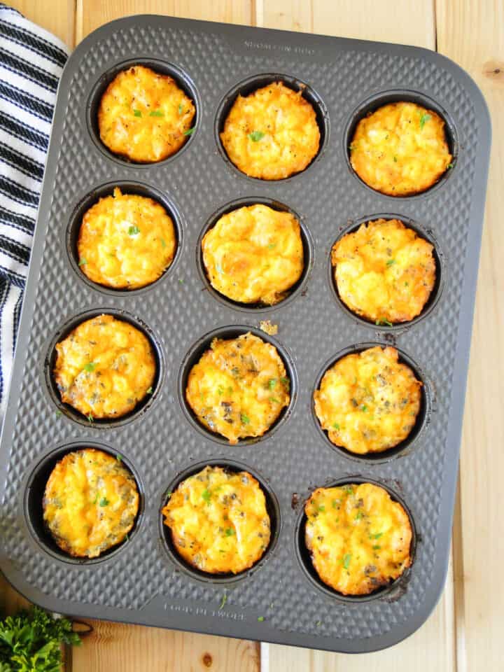 Top view of ham and cheese mini frittatas in muffin pan.