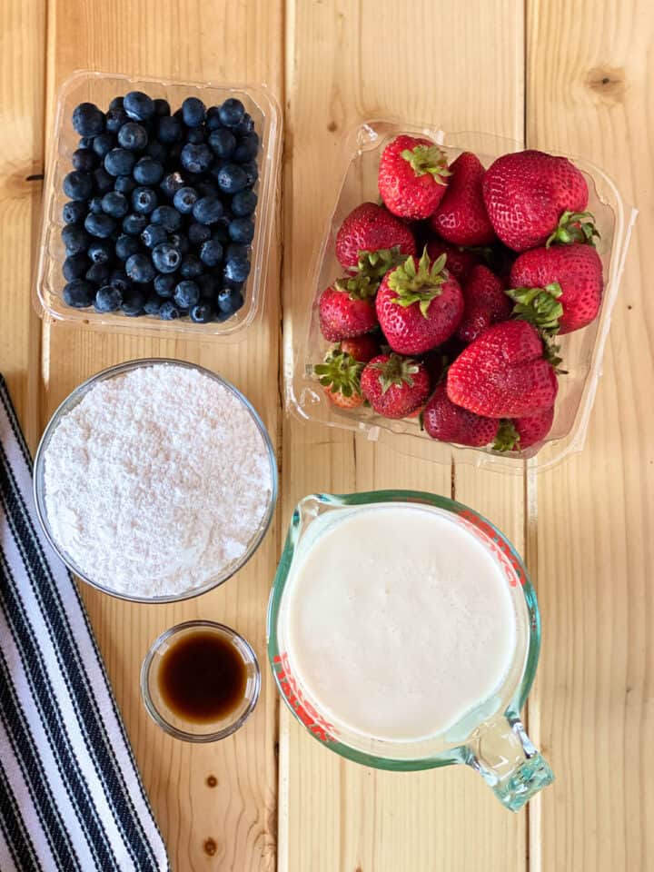 Whipped cream frosting ingredients and fresh fruit.