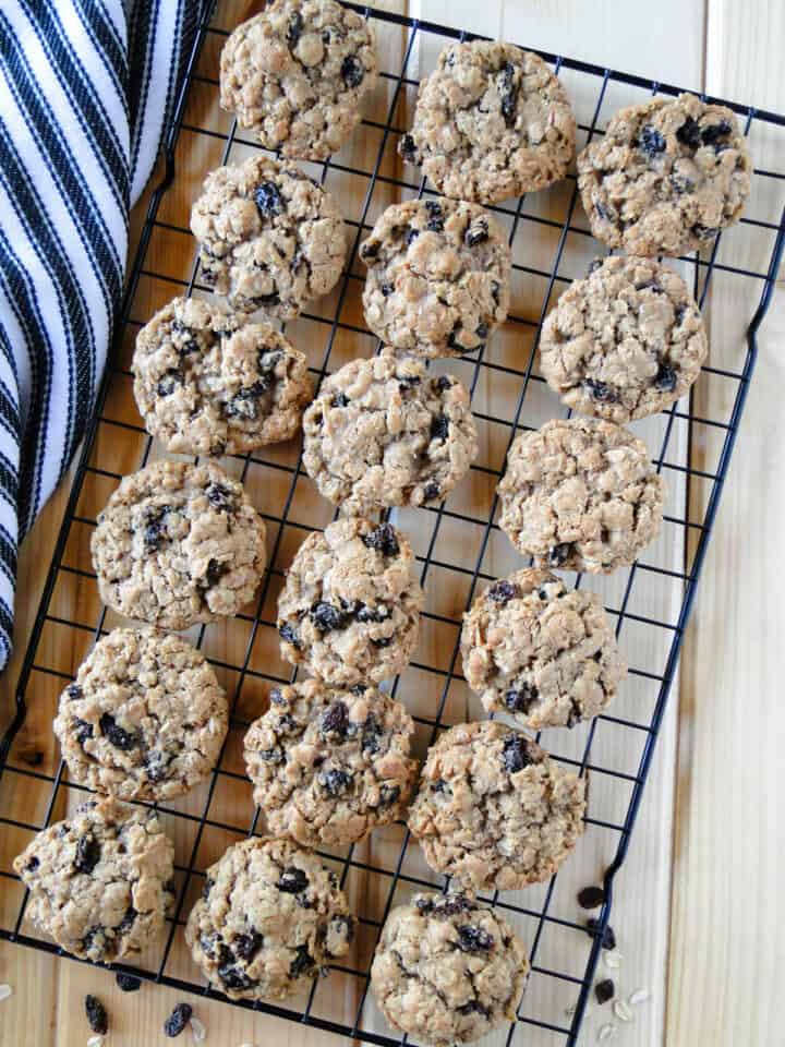 Top view of oatmeal raisin cookies in rows on wire rack.