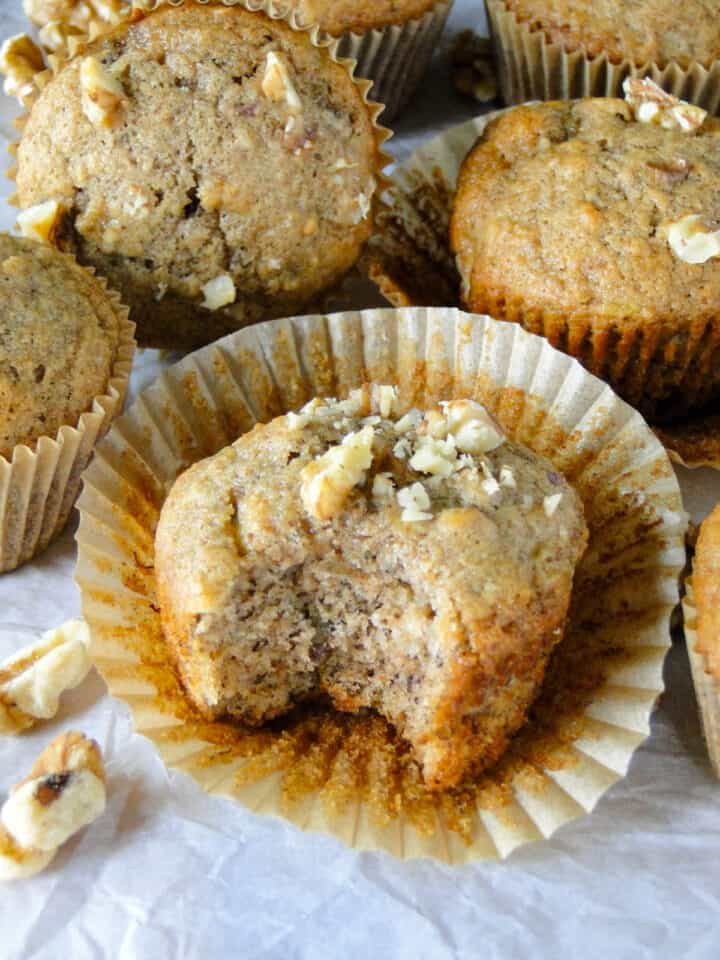 Side view of banana nut muffin with bite taken out of it.