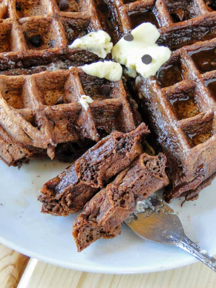 Close up view of bite of chocolate waffles on fork.