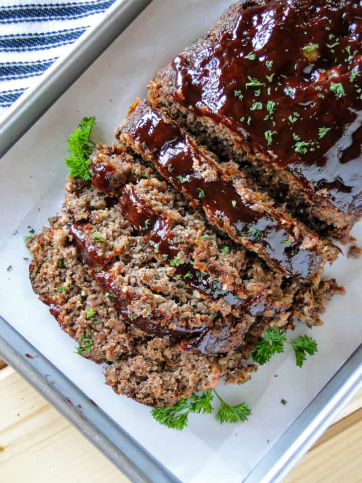 Top view of bbq meatloaf on sheet pan sliced.