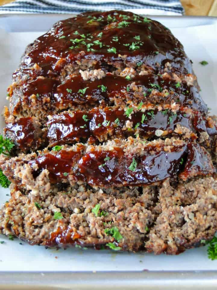 Close up front view of bbq meatloaf slices on sheet pan.