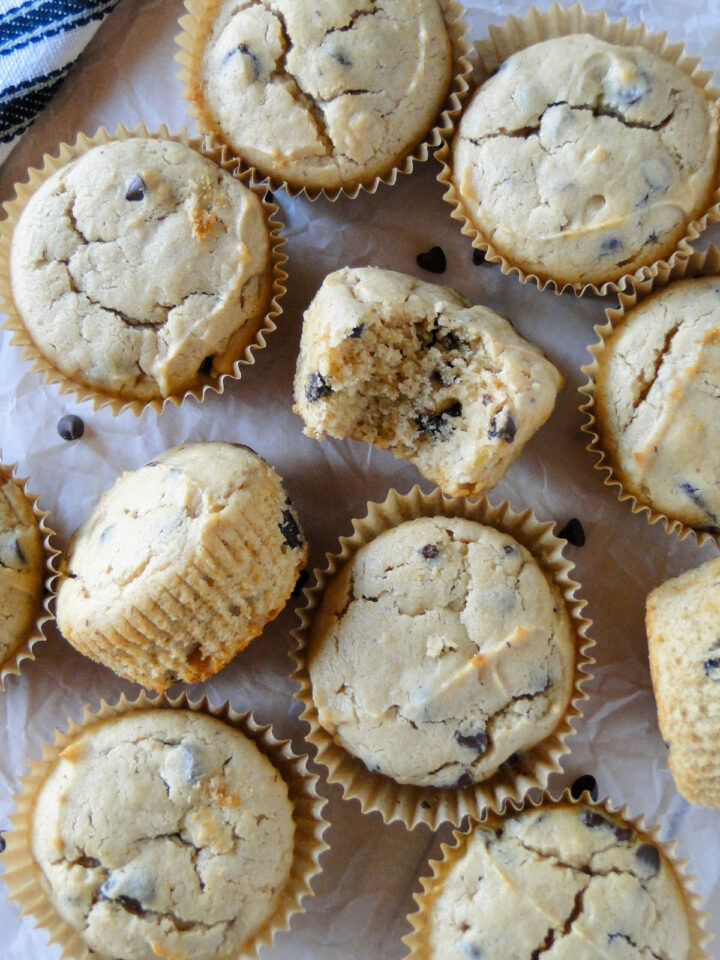 Peanut butter muffins with two muffins on their side and one with a bite taken out.