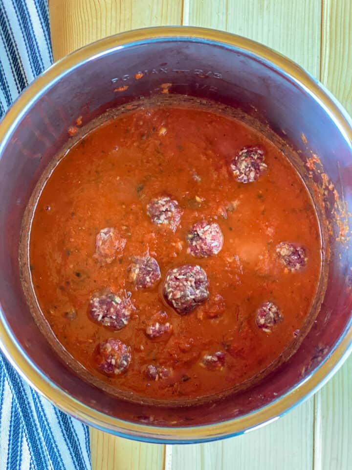 Meatballs added to sauce in instant pot.