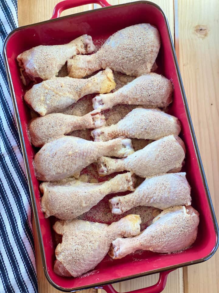 Chicken legs in baking dish seasoned.