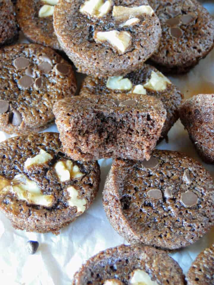 Homemade brownie bites in a pile with a bite out of one brownie.