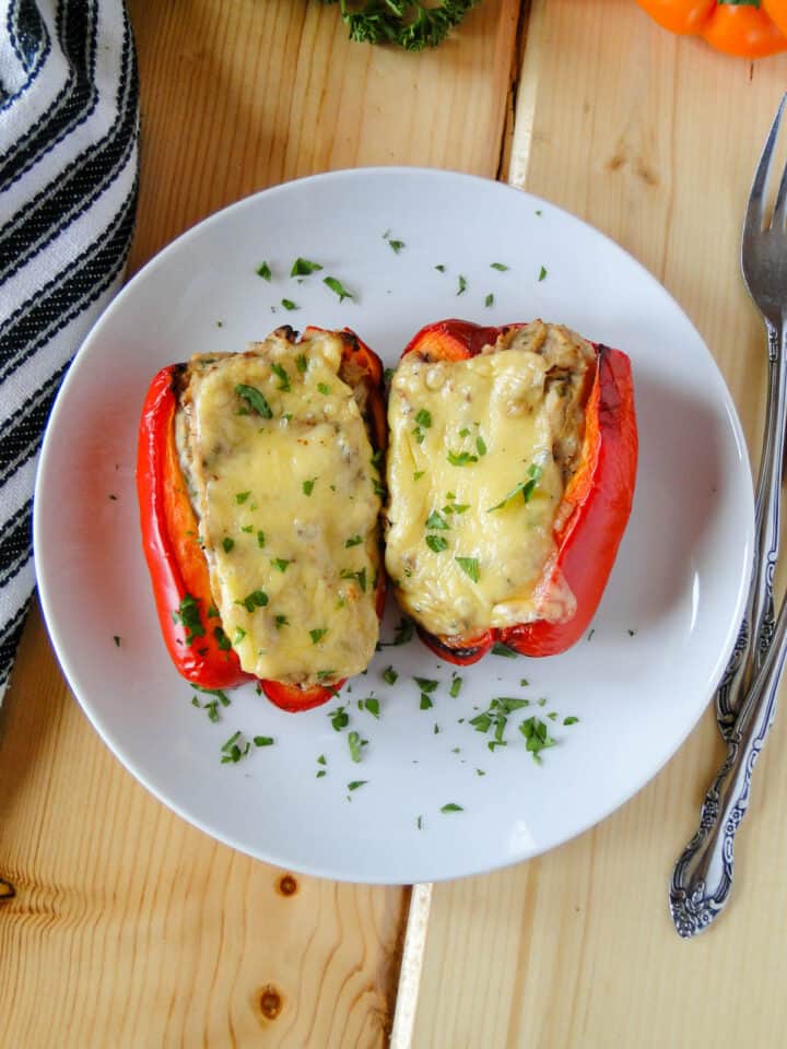 Tuna stuffed peppers on white round plate.