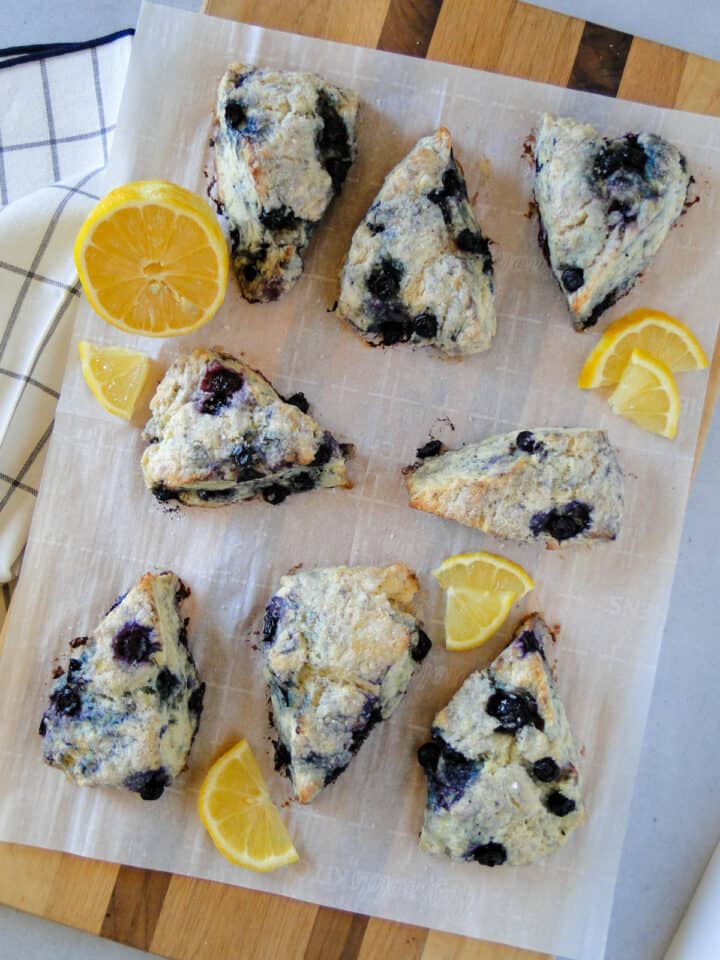 Top view of blueberry scones arranged on cutting board.