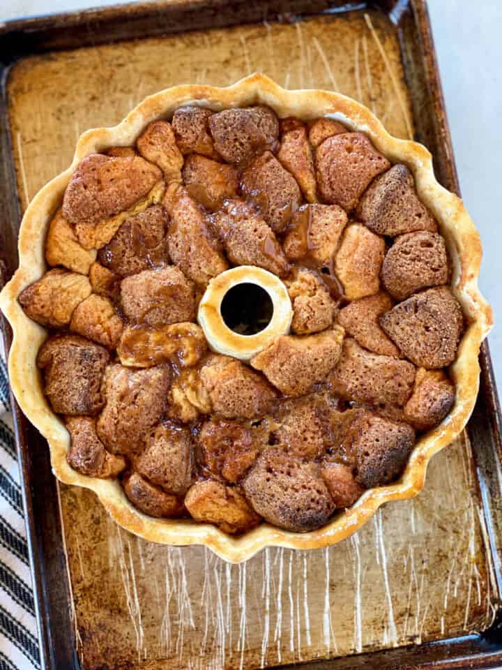 Baked monkey bread still in bundt pan on sheet pan.