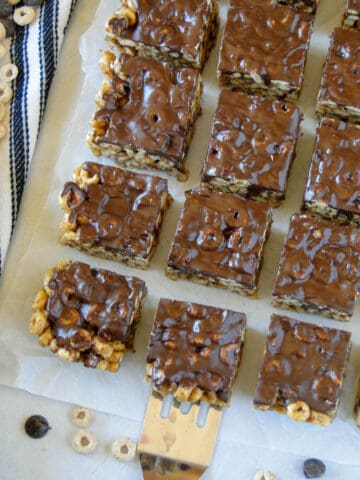 Top view of peanut butter bars with one bar in the center on top of a spatula.