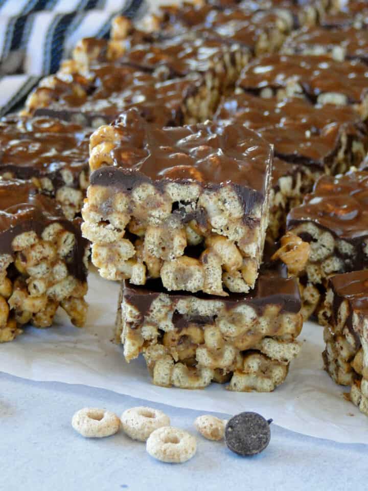 Side view of two peanut butter cereal bars stacked on top of each other.