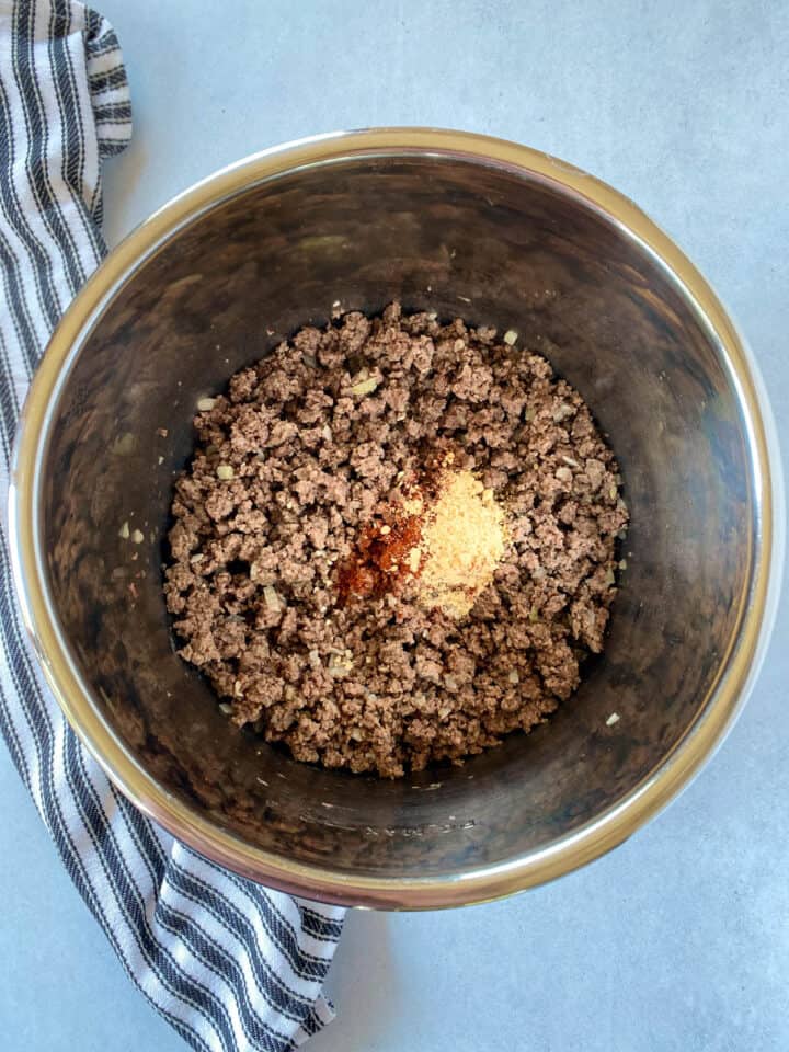 Spices added to cooked beef and onions.