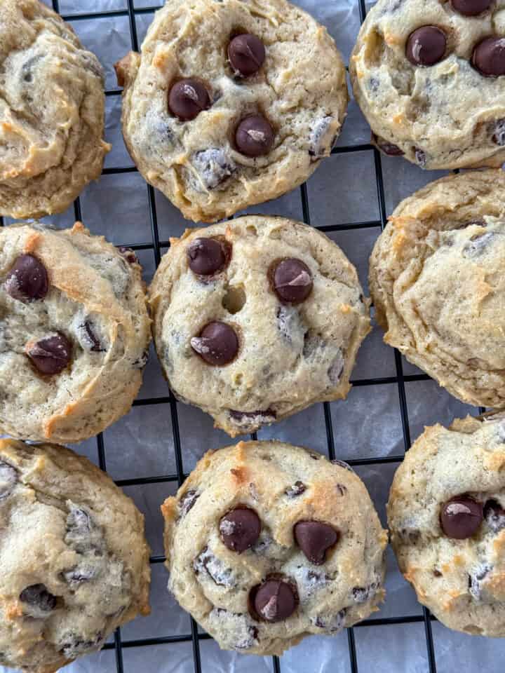Close up of cream cheese chocolate chip cookies in rows on wire rack.