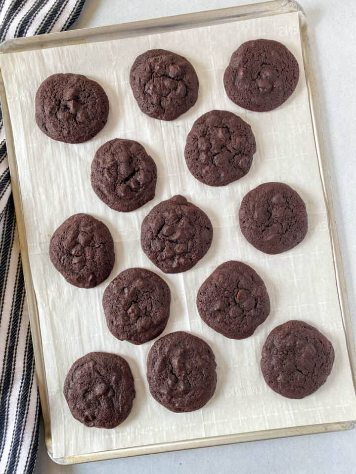 Baked cookies on parchment lined cookie sheet.