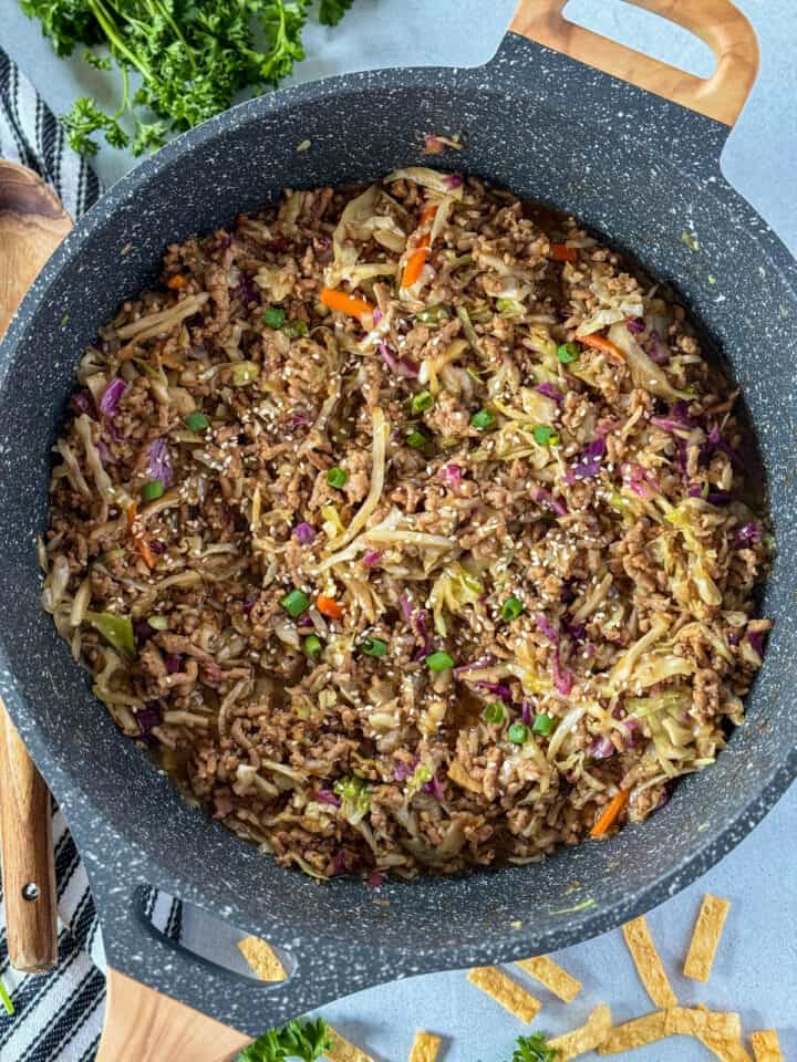 Easy egg roll in a bowl in large skillet with serving soon on the side.