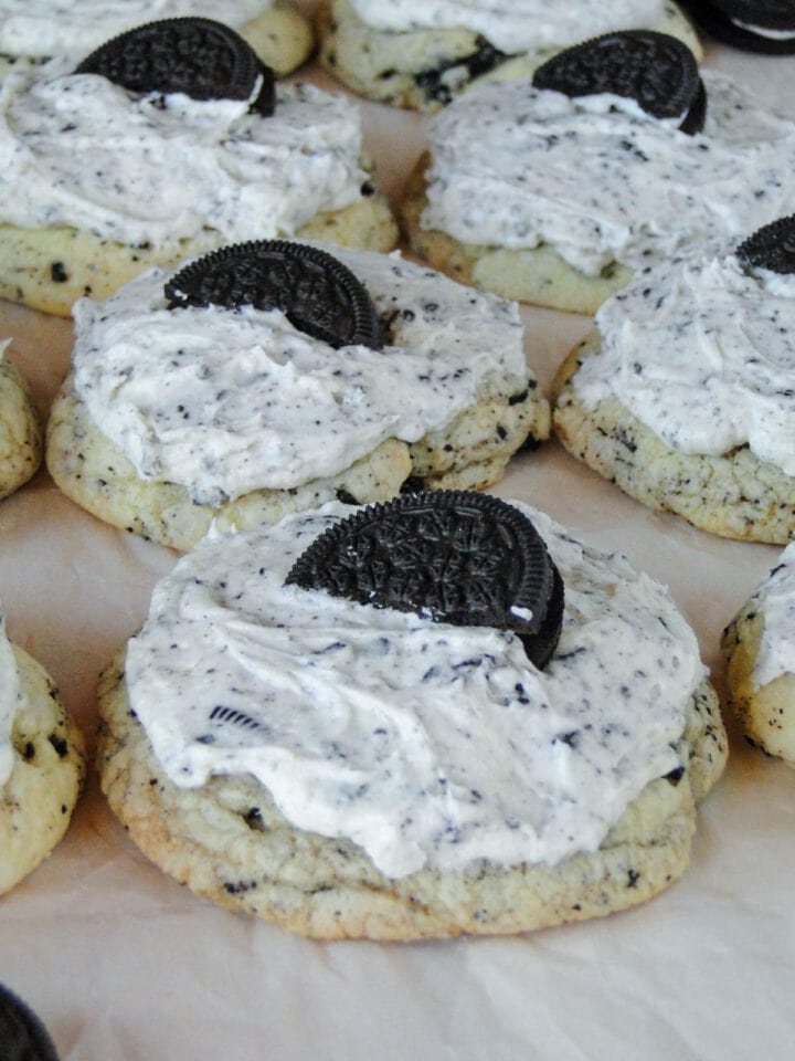 Close up side view of frosted cookies and cream cookies.