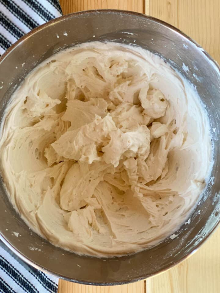 Mixed buttercream frosting in large mixing bowl.