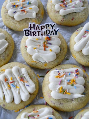 Birthday cake cookies in rows with a happy birthday pic in center cookie.