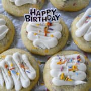 Birthday cake cookies in rows with a happy birthday pic in center cookie.