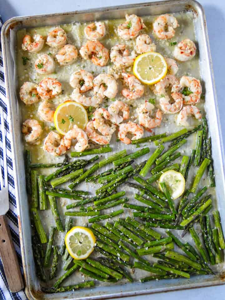 Top view of sheet pan shrimp scampi with shrimp on top and asparagus on bottom.