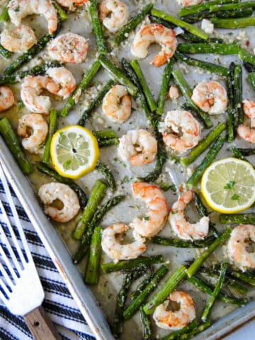 Top view of sheet pan shrimp scampi with fish spatula on the side.
