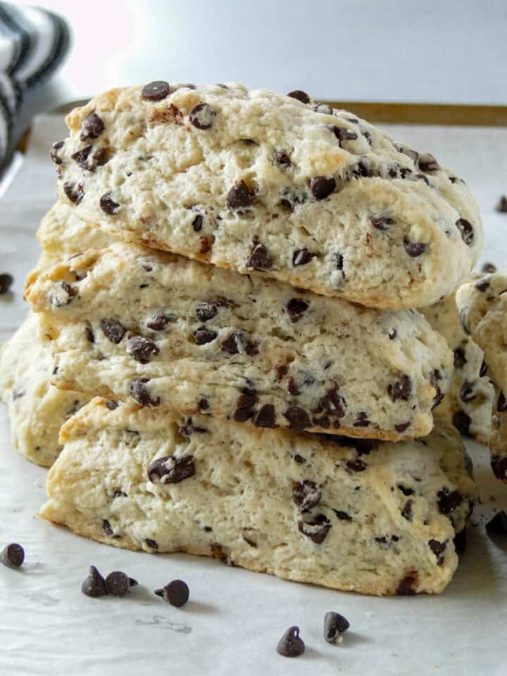 Close up side view of three chocolate chip scones stacked.