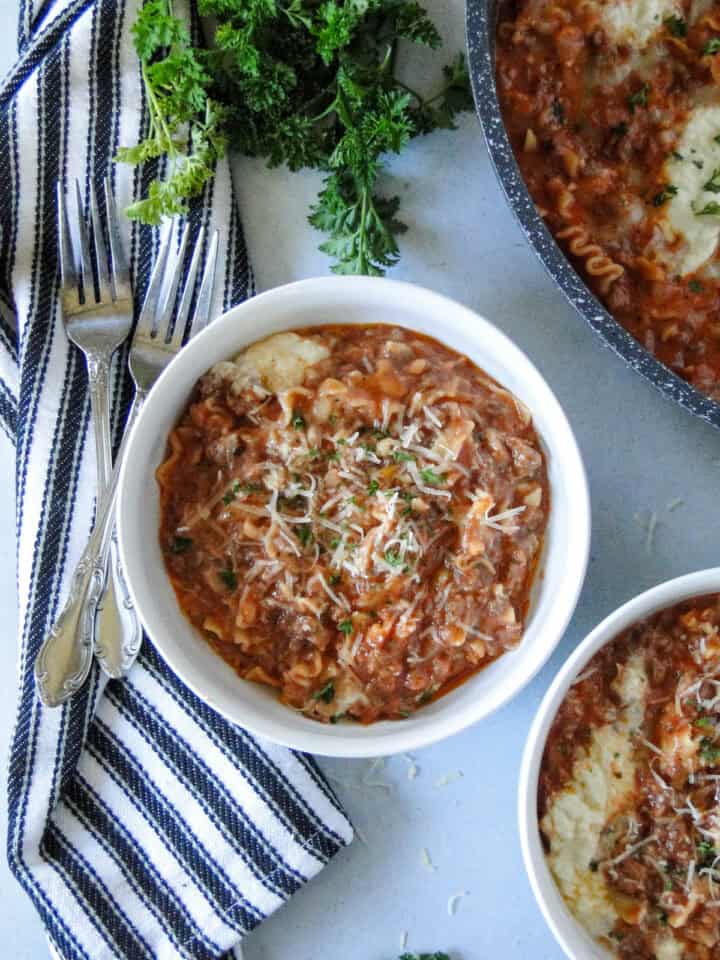 Top view of lasagna skillet in bowl with fork on the left side.