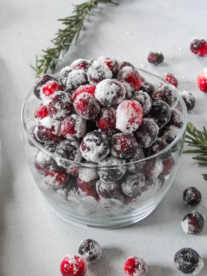 Easy sugared cranberries in holiday glass bowl.