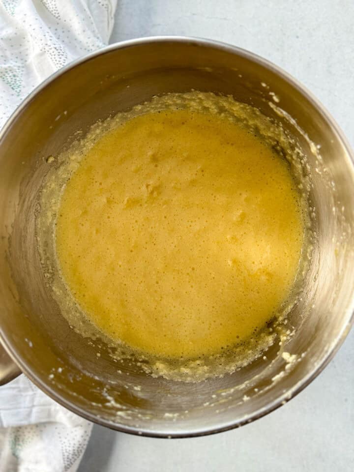 Wet ingredients combined in metal mixing bowl.