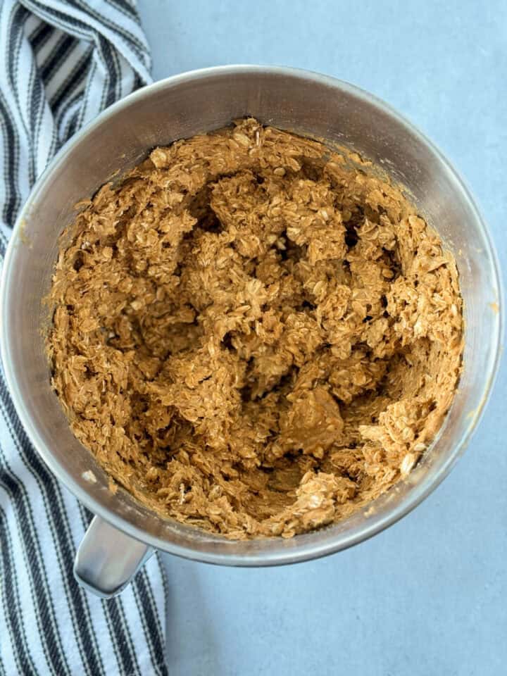 Peanut butter, oats, and flour mixed into wet ingredients.
