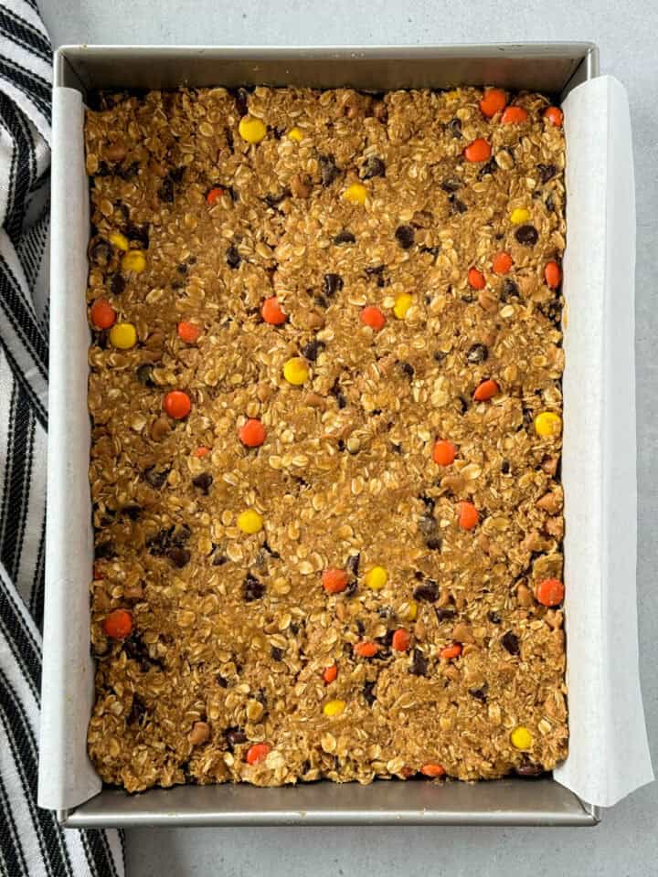 Cookie dough gently pressed in parchment lined 9x13 baking dish.