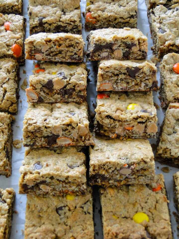 Monster cookie bars layered on top of each other in two columns.