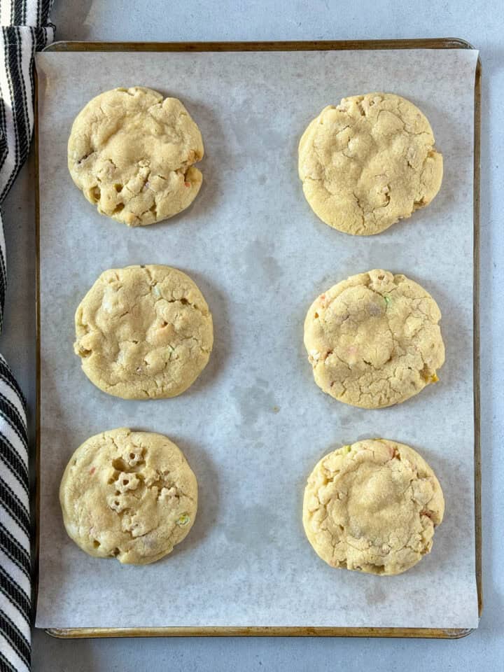 Baked cookies on parchment lined cookie sheet.