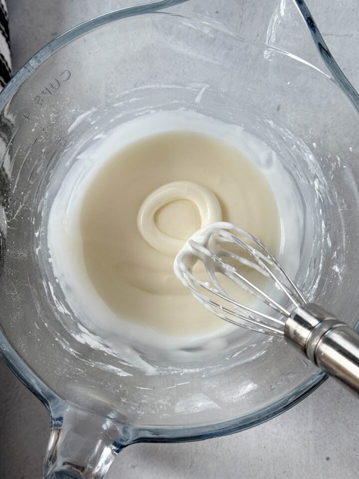 Lemon glaze in medium batter bowl with whisk.