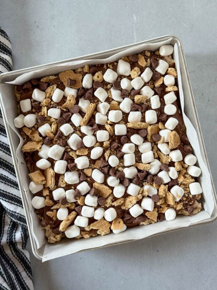 Extra marshmallows, chocolate chips and graham crackers added on top of melted chocolate.