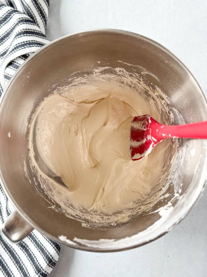 Marshmallow filling in large mixing bowl with red spatula.