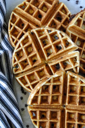 Chocolate chip waffles layered in a row.