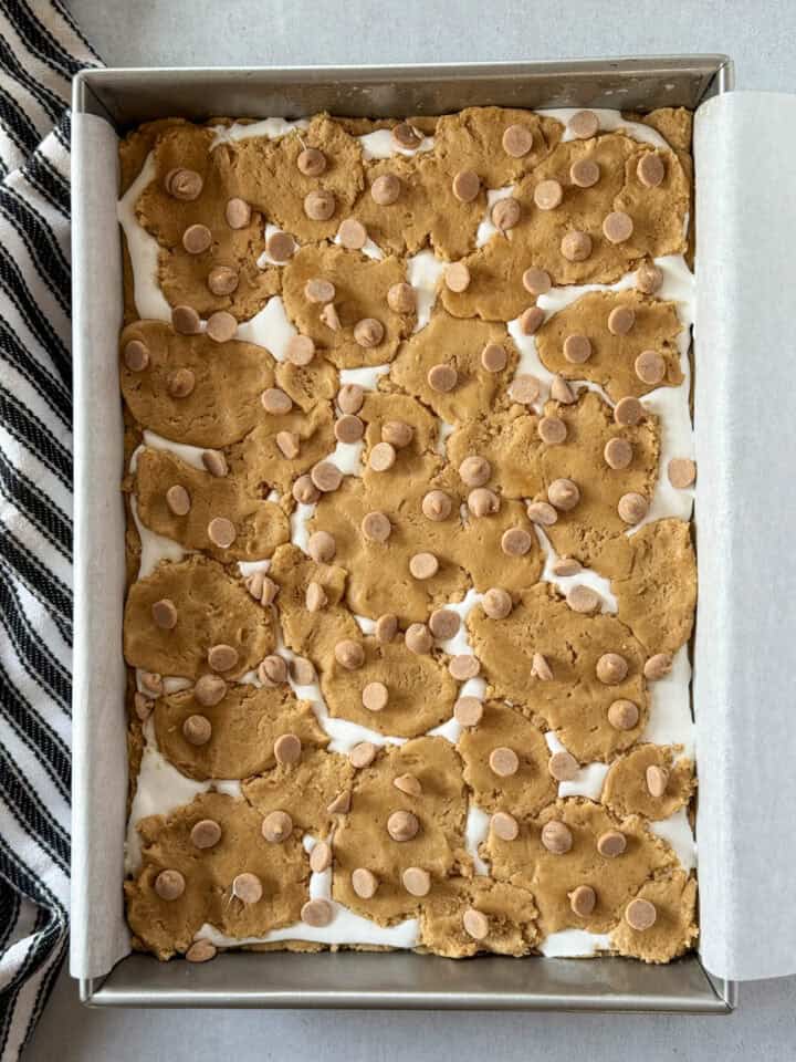 Remaining dough placed on top of marshmallow fluff and sprinkled with peanut butter chips.
