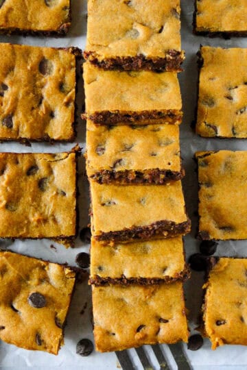 Pumpkin chocolate chip bars layered in a row with more bars on the side.