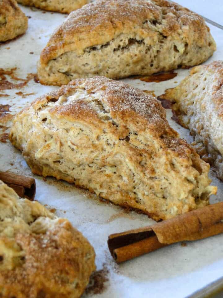 Close up side view of baked apple cinnamon scone on sheet pan.
