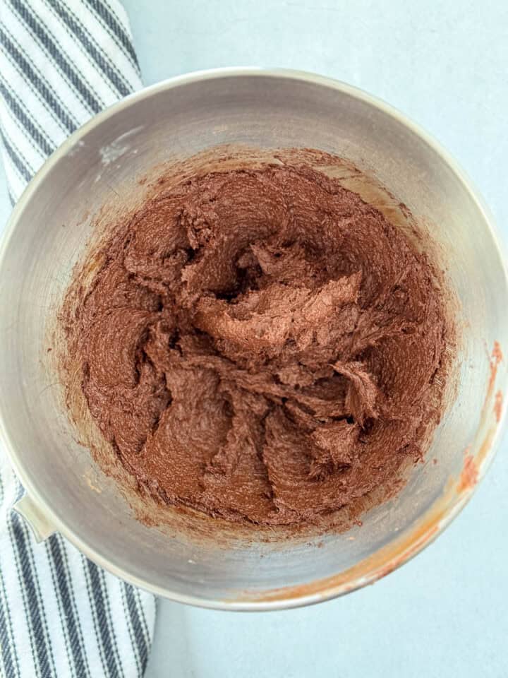 Egg beaten into creamed butter and sugars in large mixing bowl.